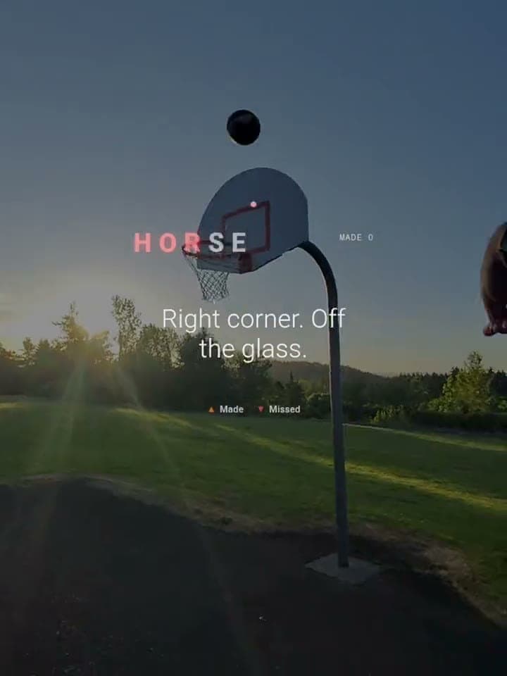 The view through the glasses on a real court: the ball above the rim under the call Right corner, off the glass